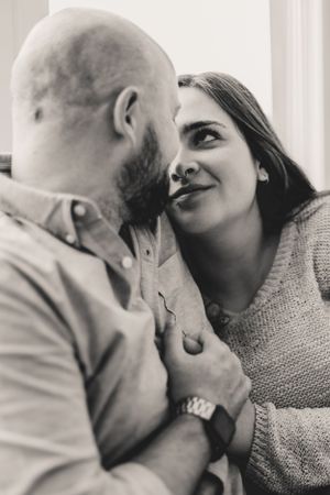 A romantic sequence of black and white photographs showing a couple sharing tender kisses and intimate moments.