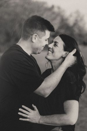 A romantic black and white photo sequence shows a couple sharing an intimate kiss outdoors.