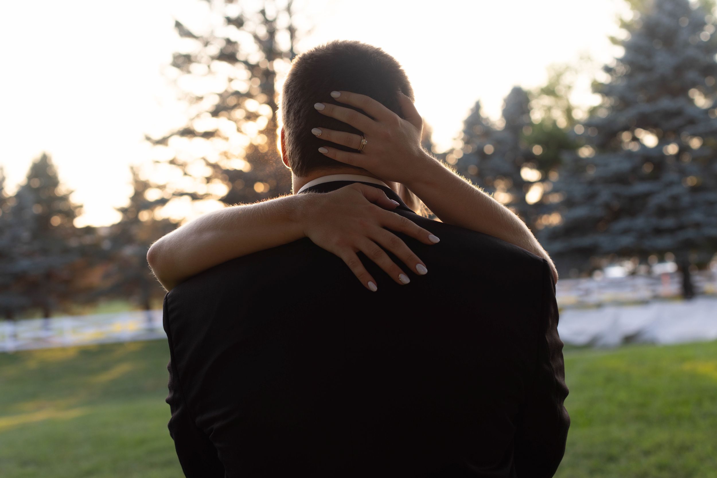 Silhouette photography session at golden hour in a suburban setting.