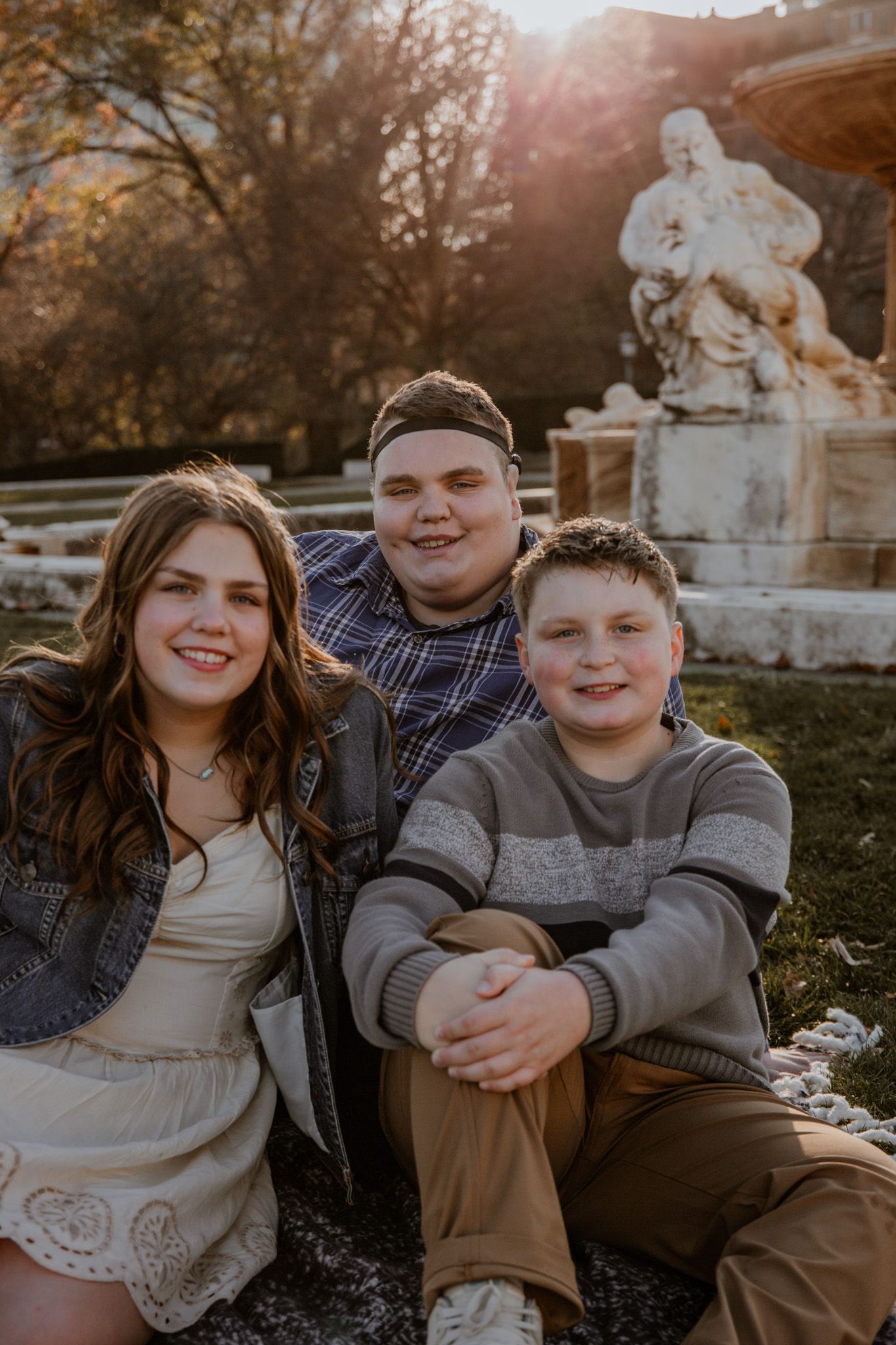 Candid family photos captured during sunset in an outdoor garden setting.