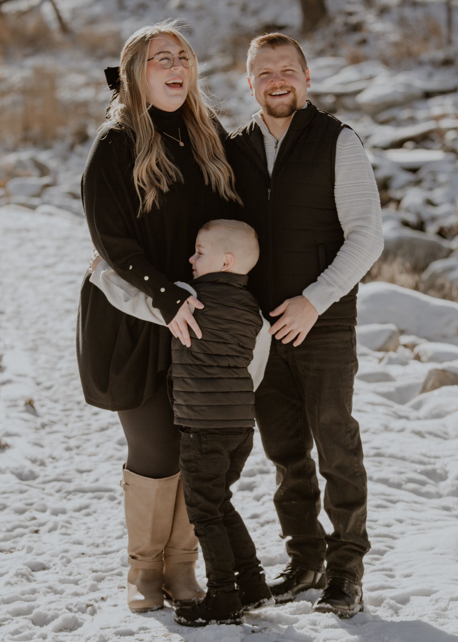 Playful family moments captured in snow-covered winter landscape.