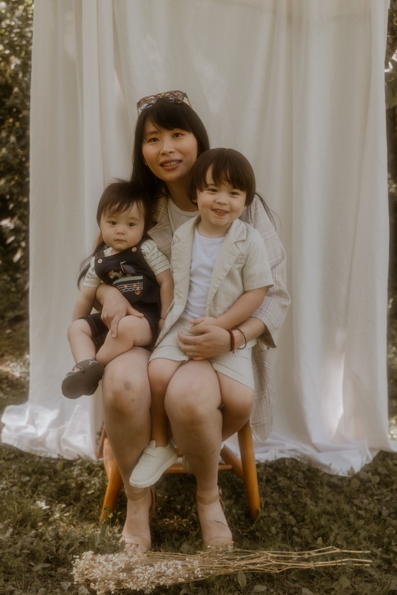 Family portrait session showing tender moments against a white backdrop.