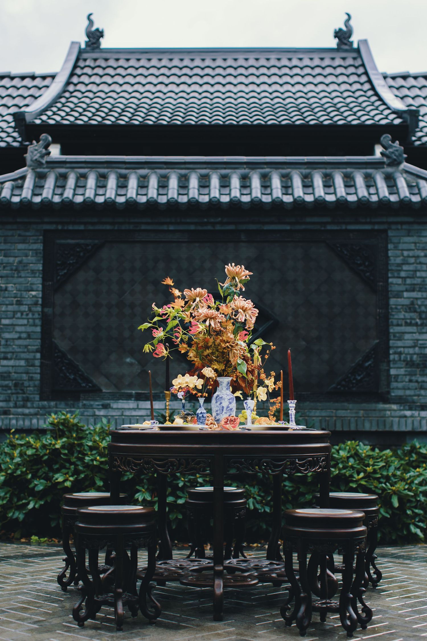 Traditional Asian pagoda-style pavilion with ornate floral centerpiece arrangement.