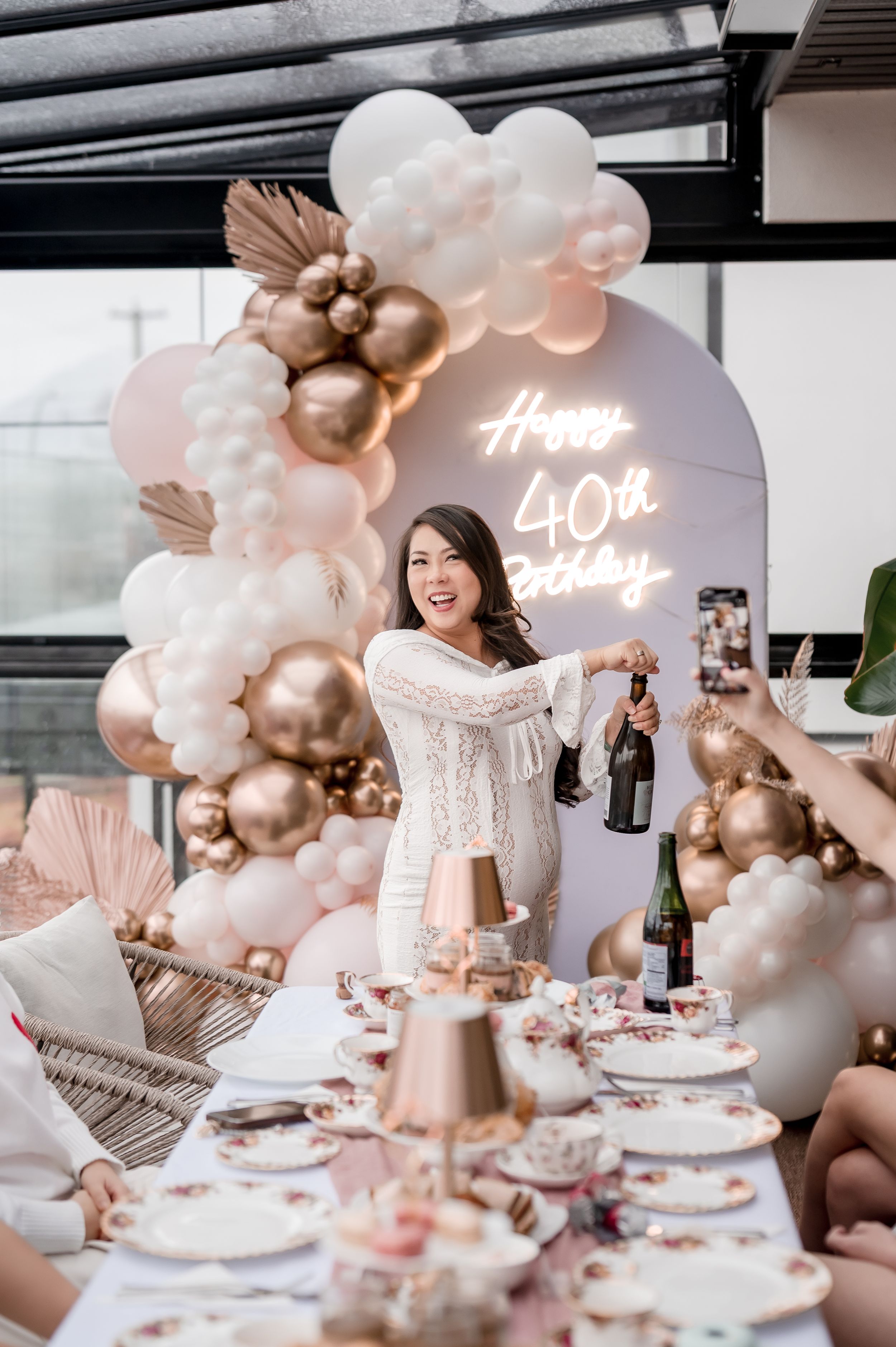 40th birthday party setup with luxurious table settings, pink balloon decor, and celebratory atmosphere.