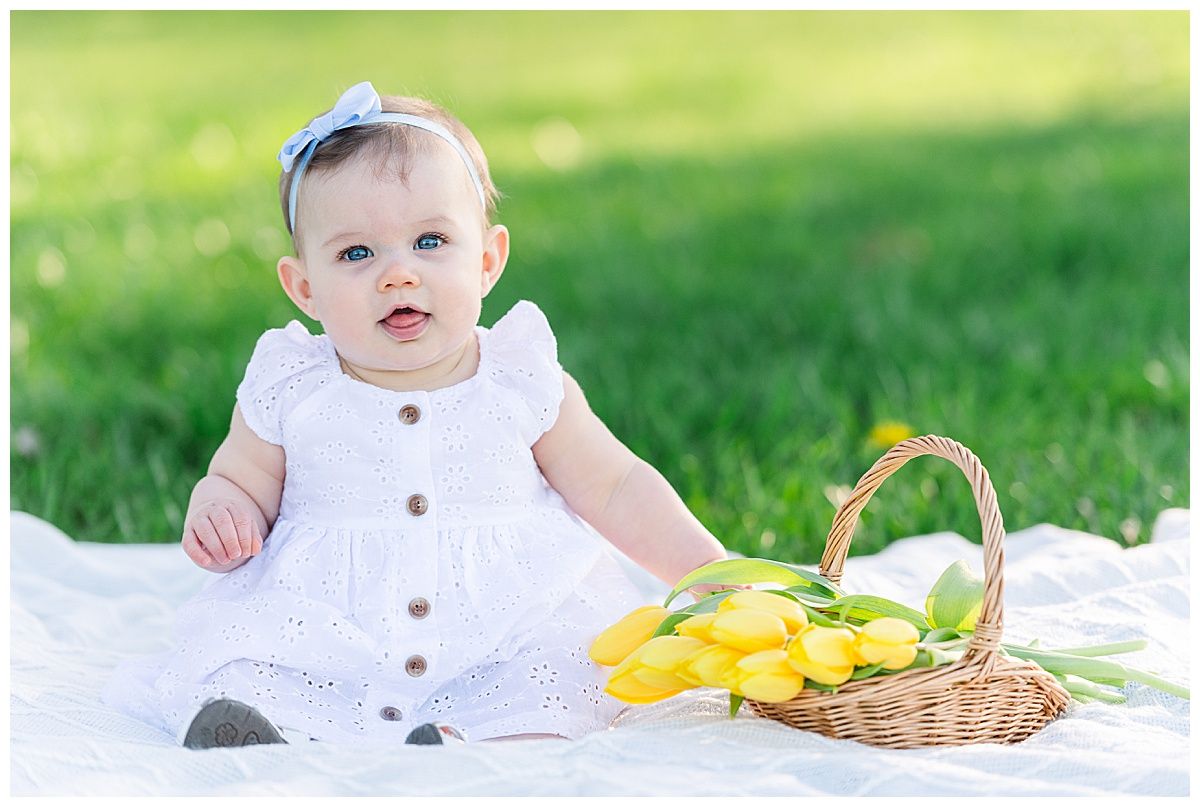 Portrait of baby girl with spring flowers at Coxhall Gardens in Carmel Indiana