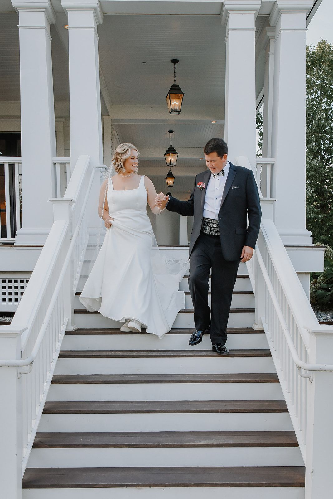 Four sequential shots of a couple sharing a romantic moment on an elegant white porch with columns during a wedding at Kimpton Taconic, VT