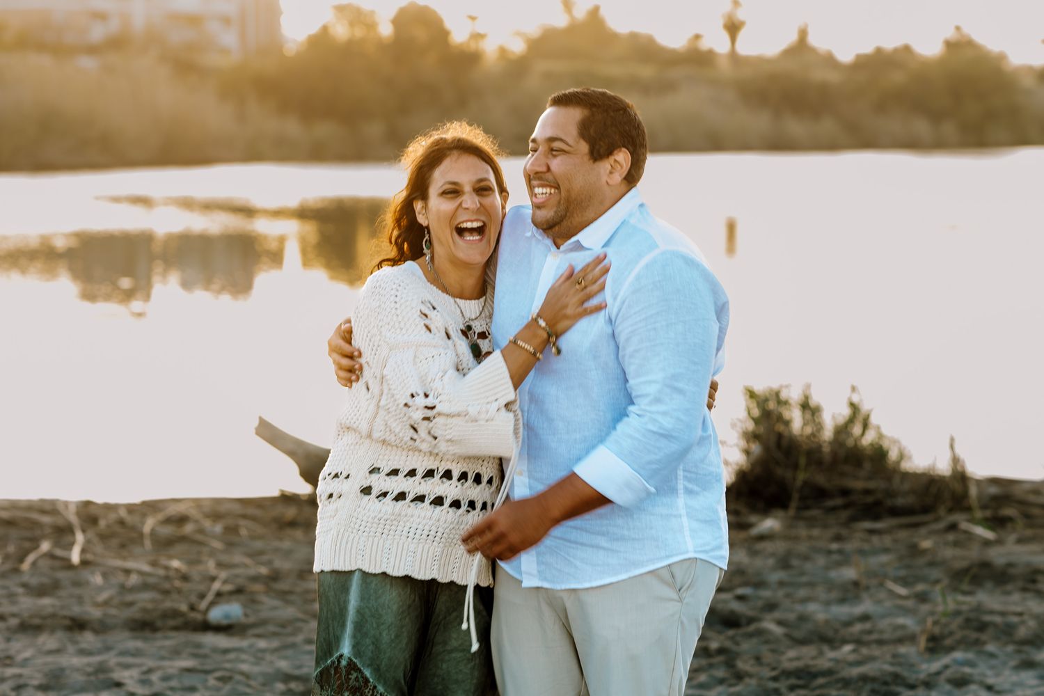Parents holding each other and laughing during photo session.