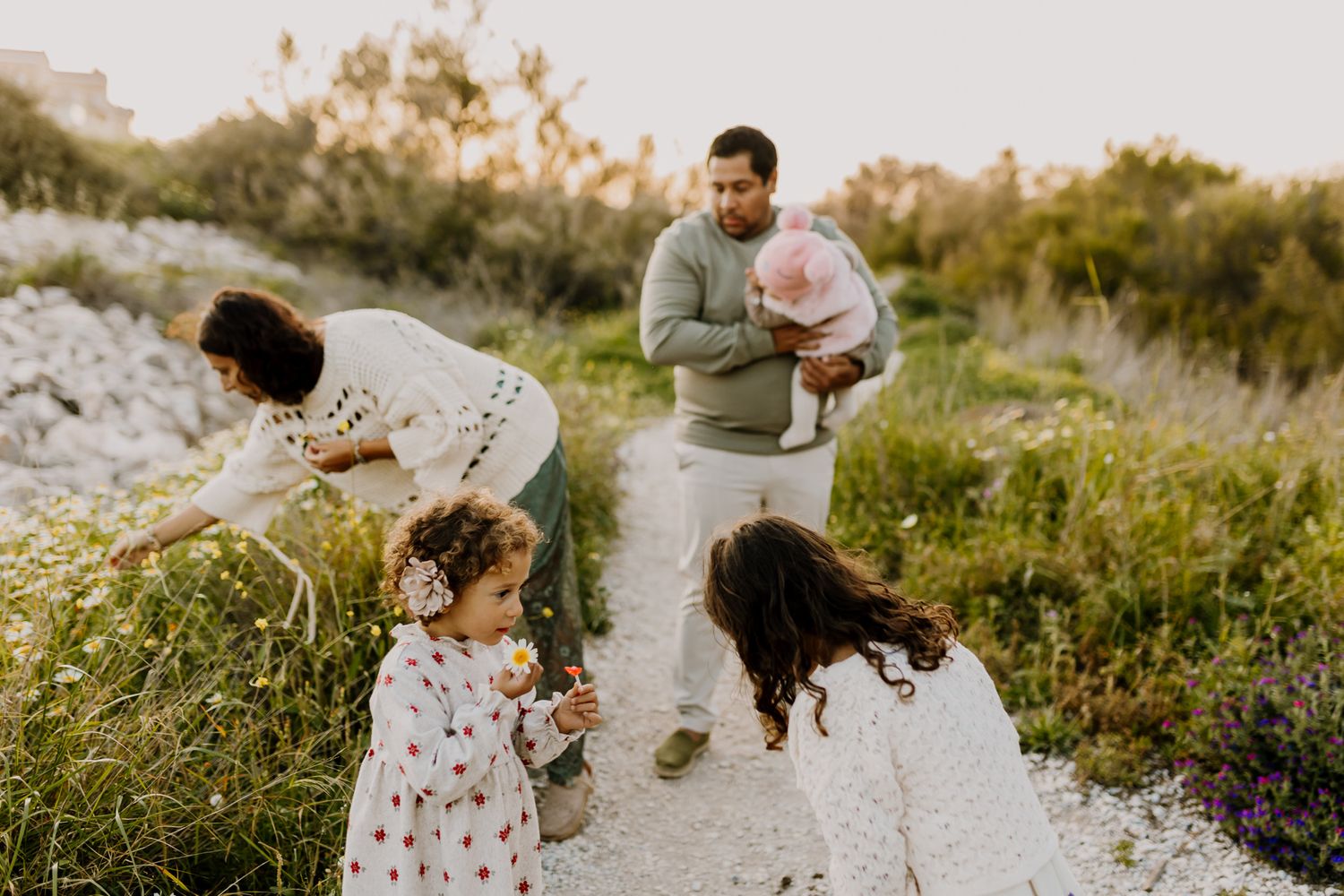 Family picking flowers at a spring photo session