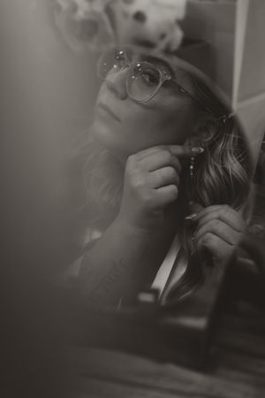 Artistic black and white portrait with soft focus and dramatic lighting.