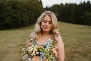 Close-up shots of bridal bouquet with delicate wildflowers and greenery.