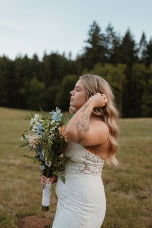 Artistic bridal portraits with natural lighting in outdoor meadow setting.