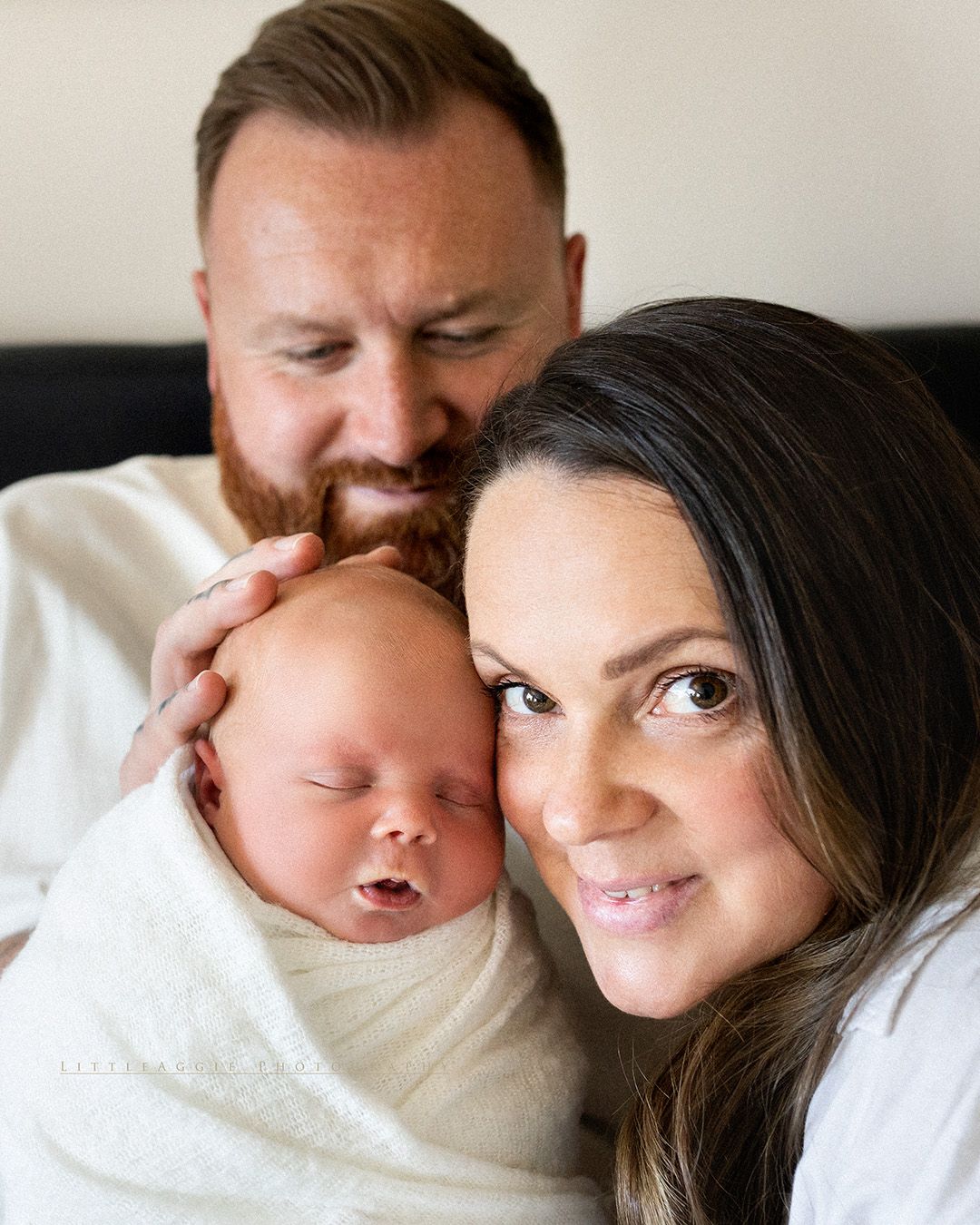 A montage of intimate parent and newborn moments showing tender kisses and snuggles in soft lighting.