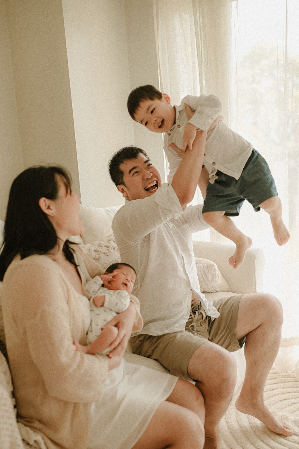 A lively family moment with playful interaction in a Bexley newborn studio.