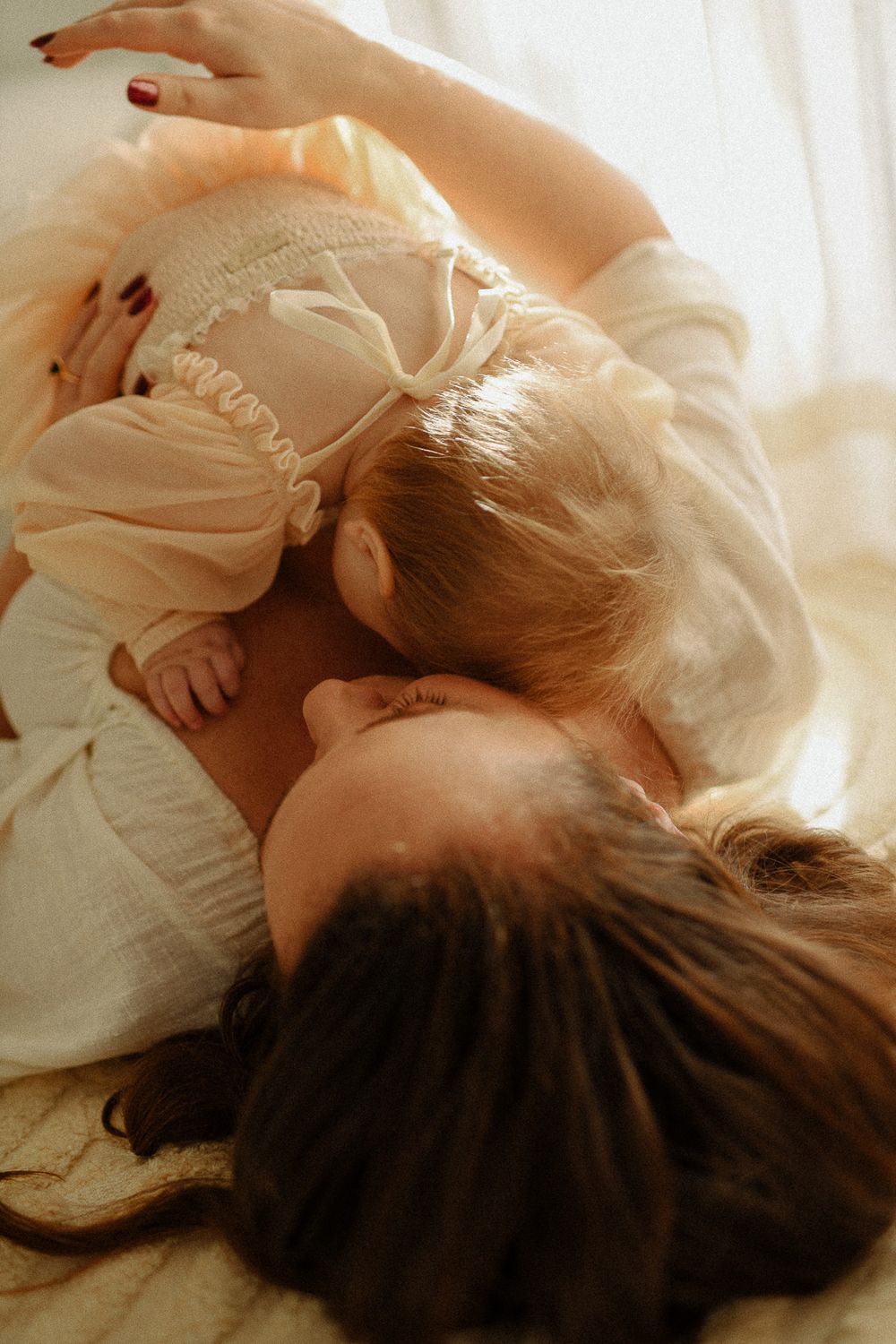 An intimate moment of parental affection captured in warm natural light.