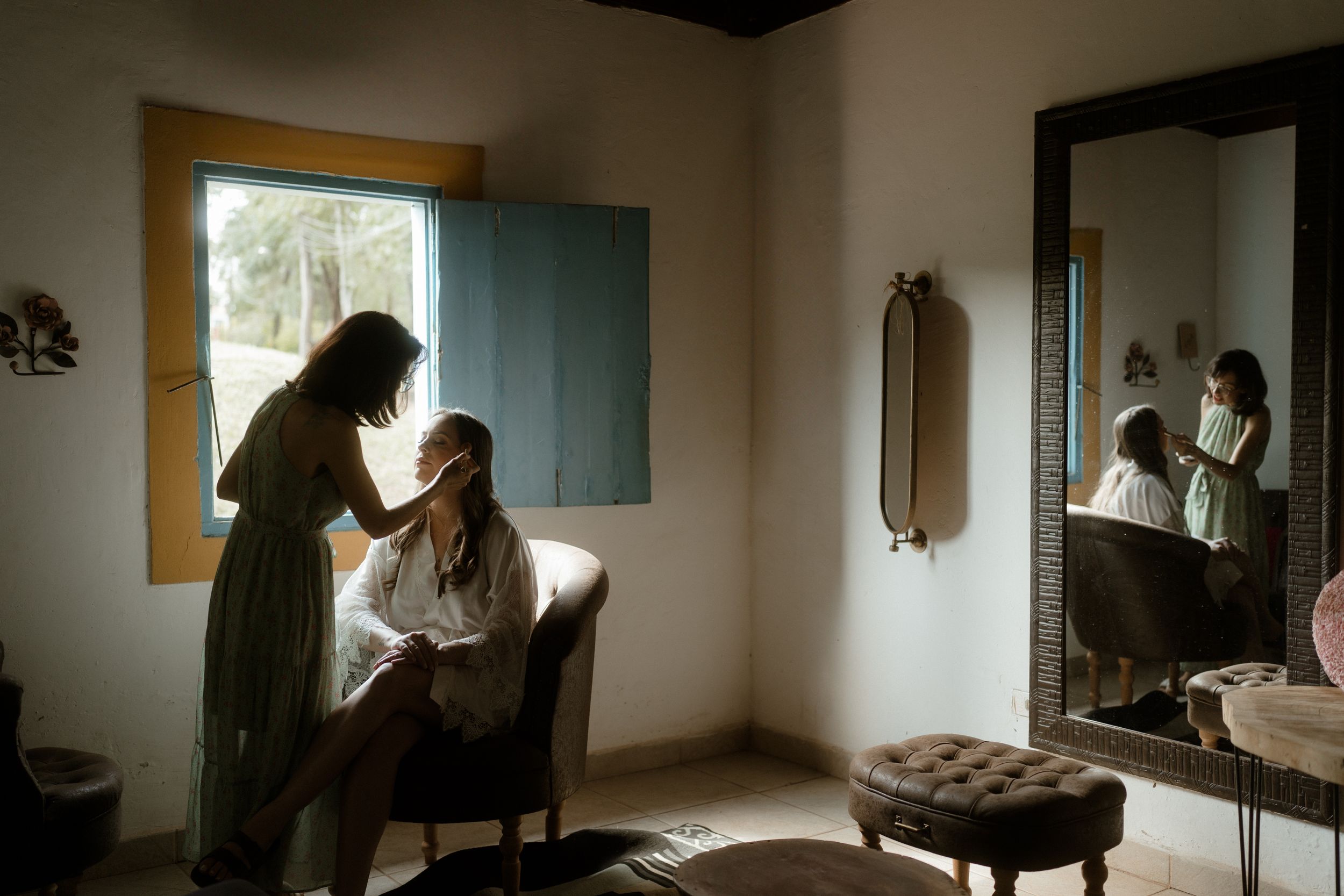 Natural light filters through window in intimate getting ready space.