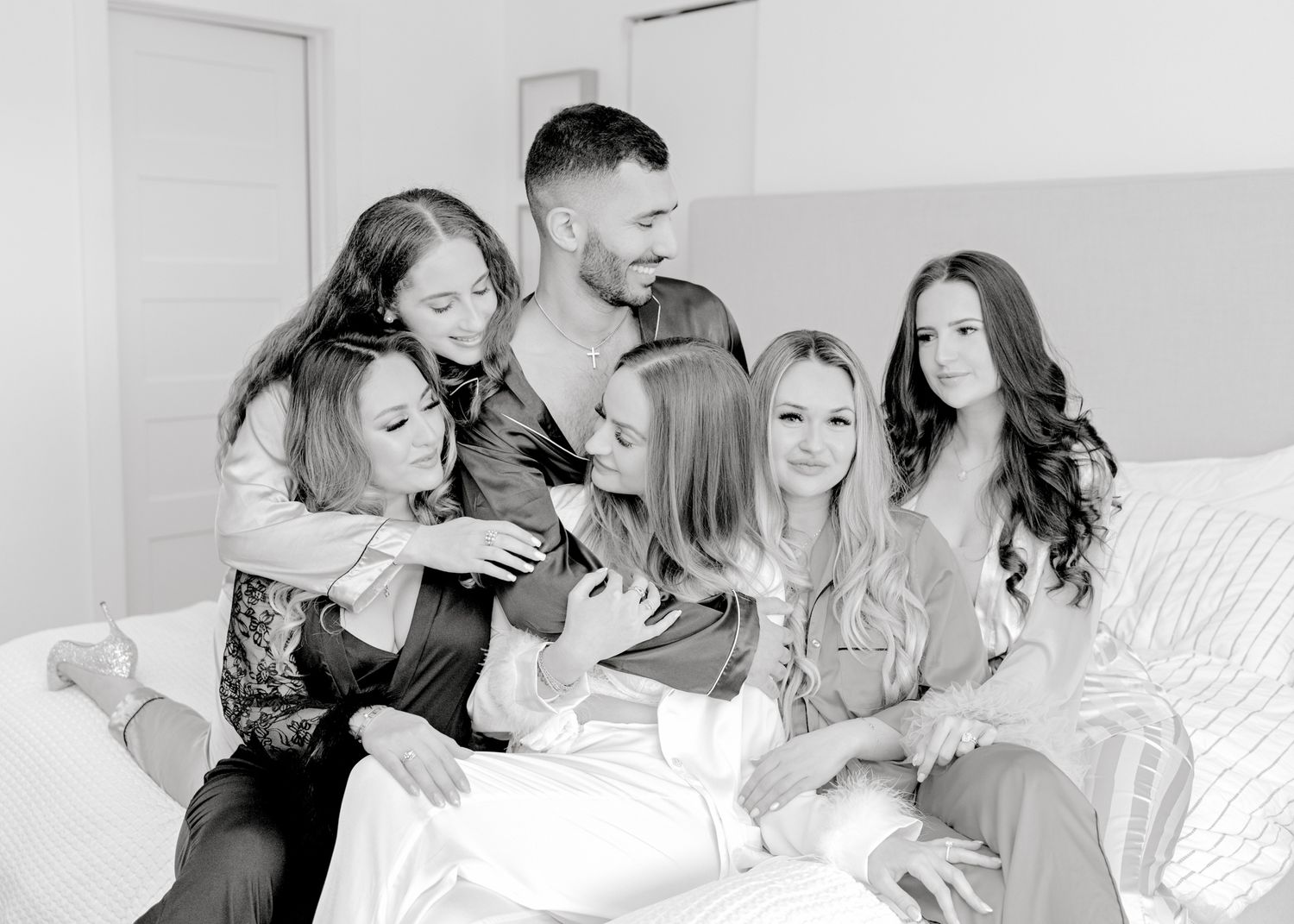 Black and white photo capturing candid moment of group on couch.