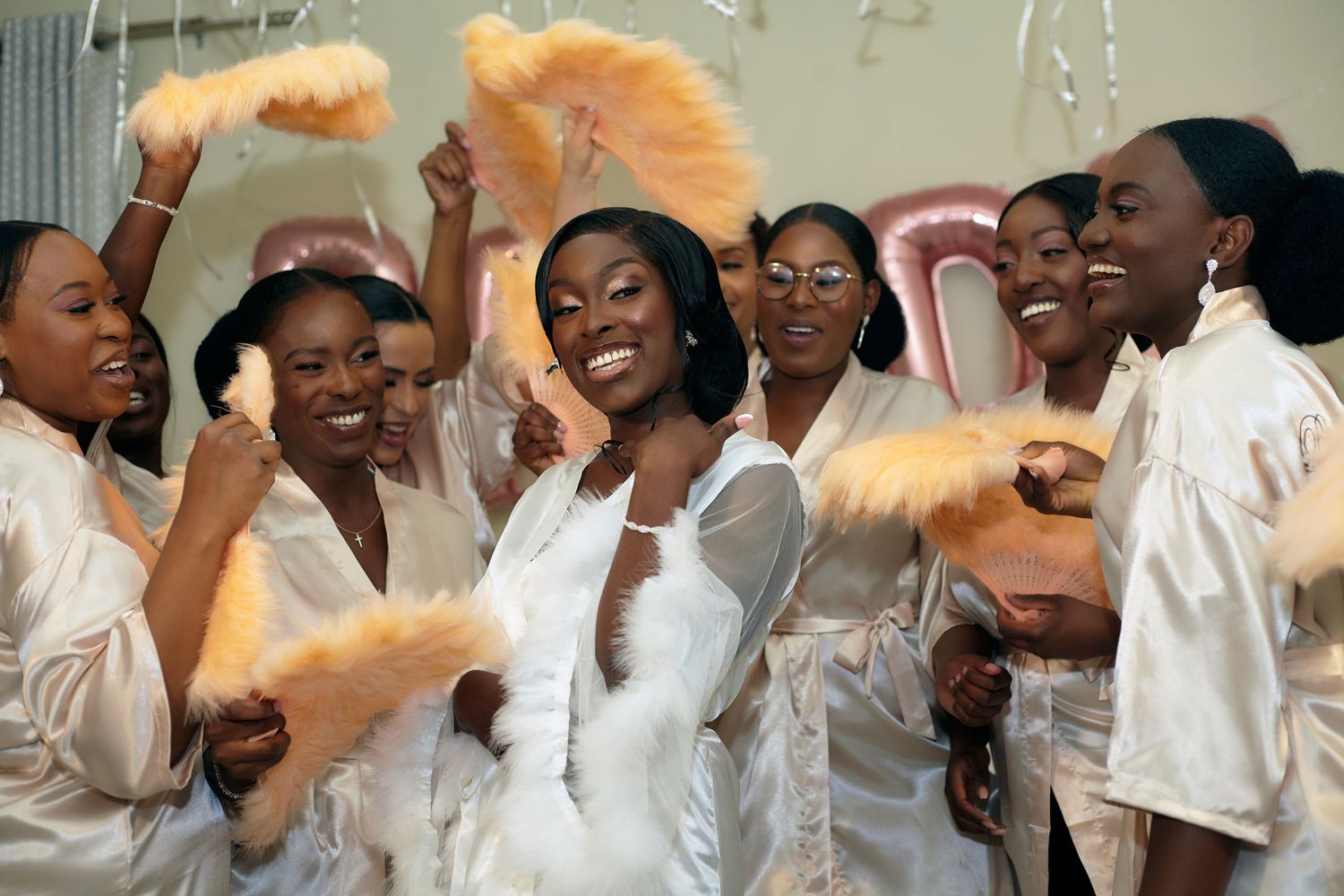 Group celebration scene with white robes and festive decorations.