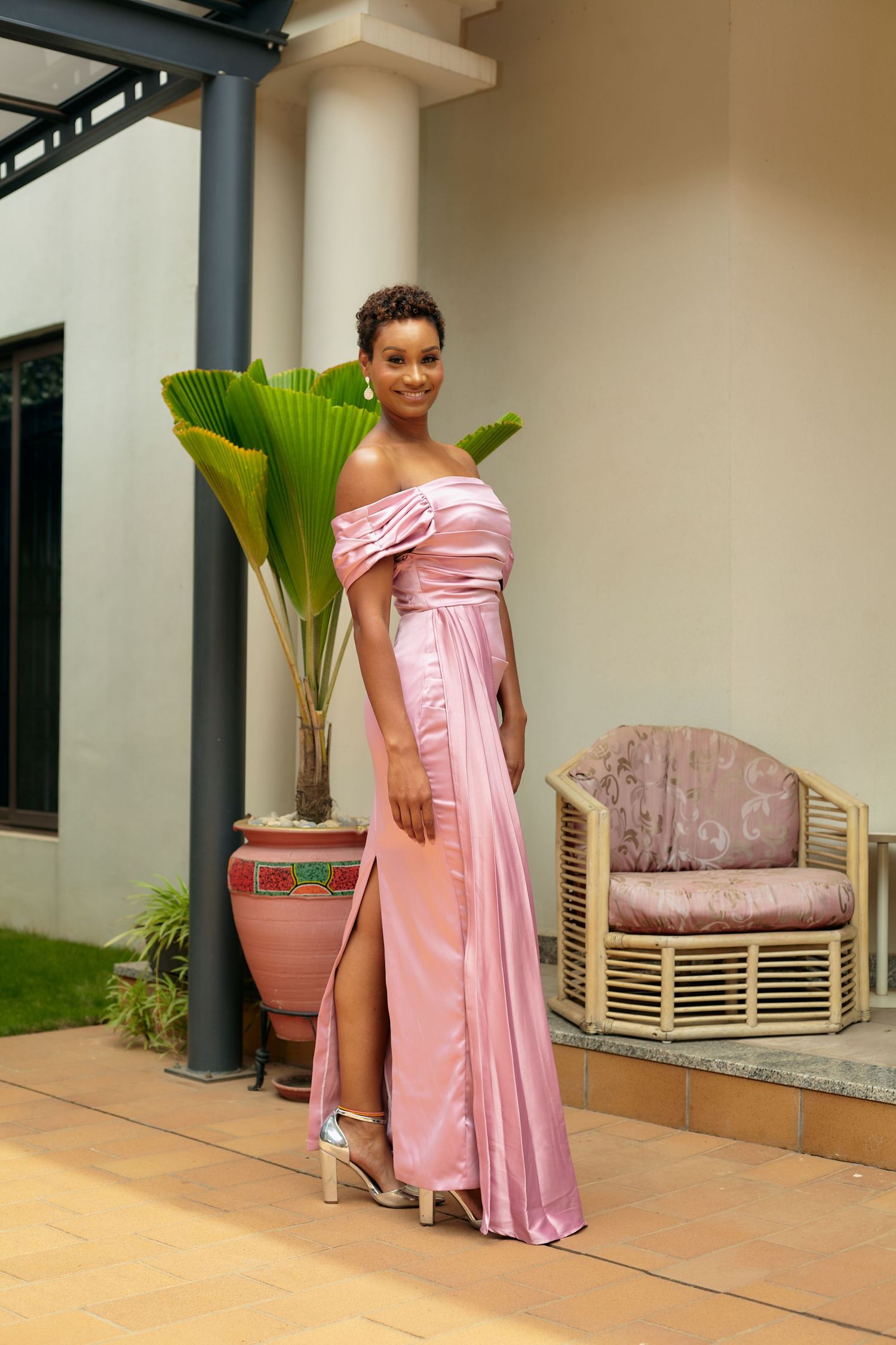 Fashion photo series featuring a pink satin gown in an outdoor setting with tropical plants.