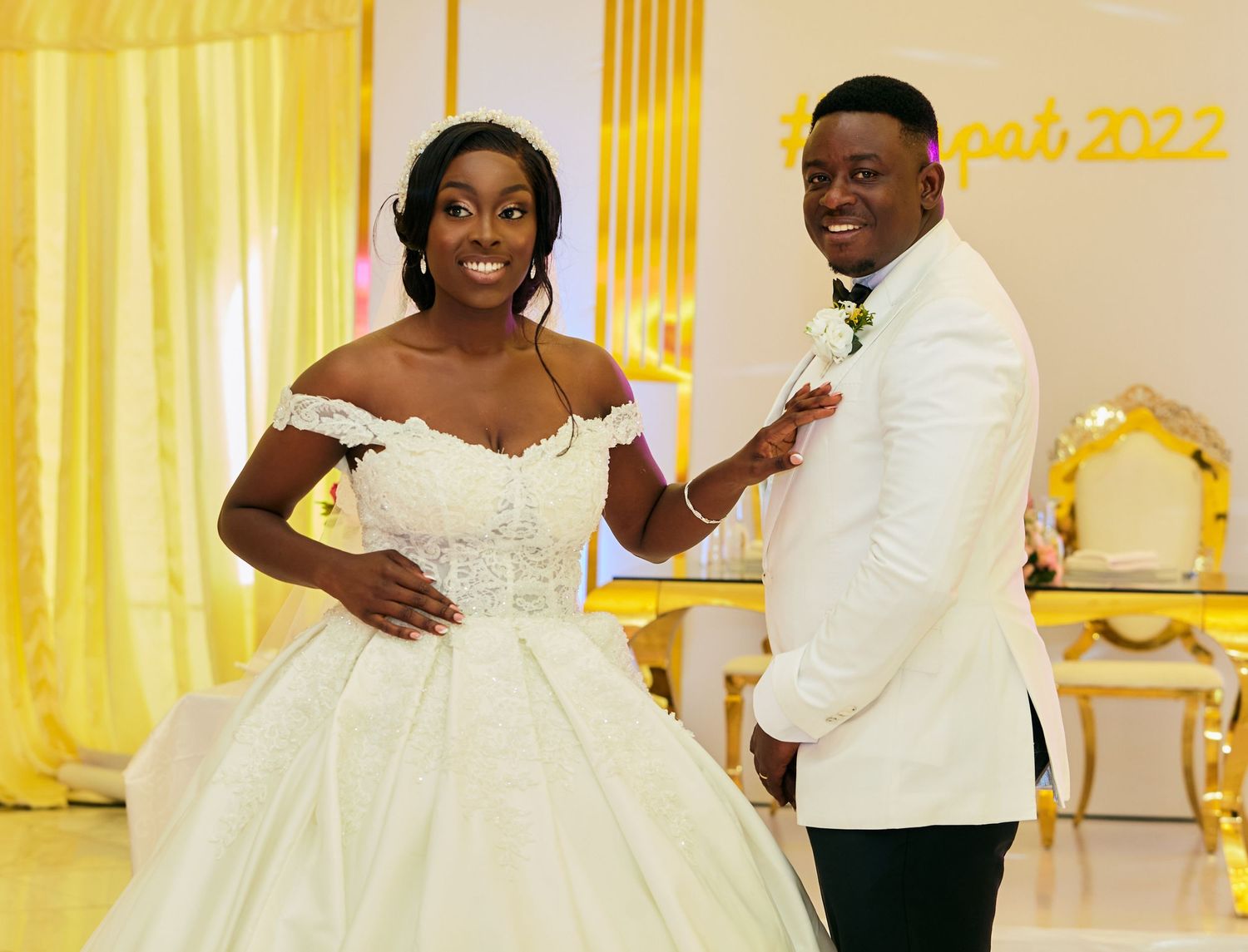 Elegant wedding celebration with yellow decor and white formal attire.