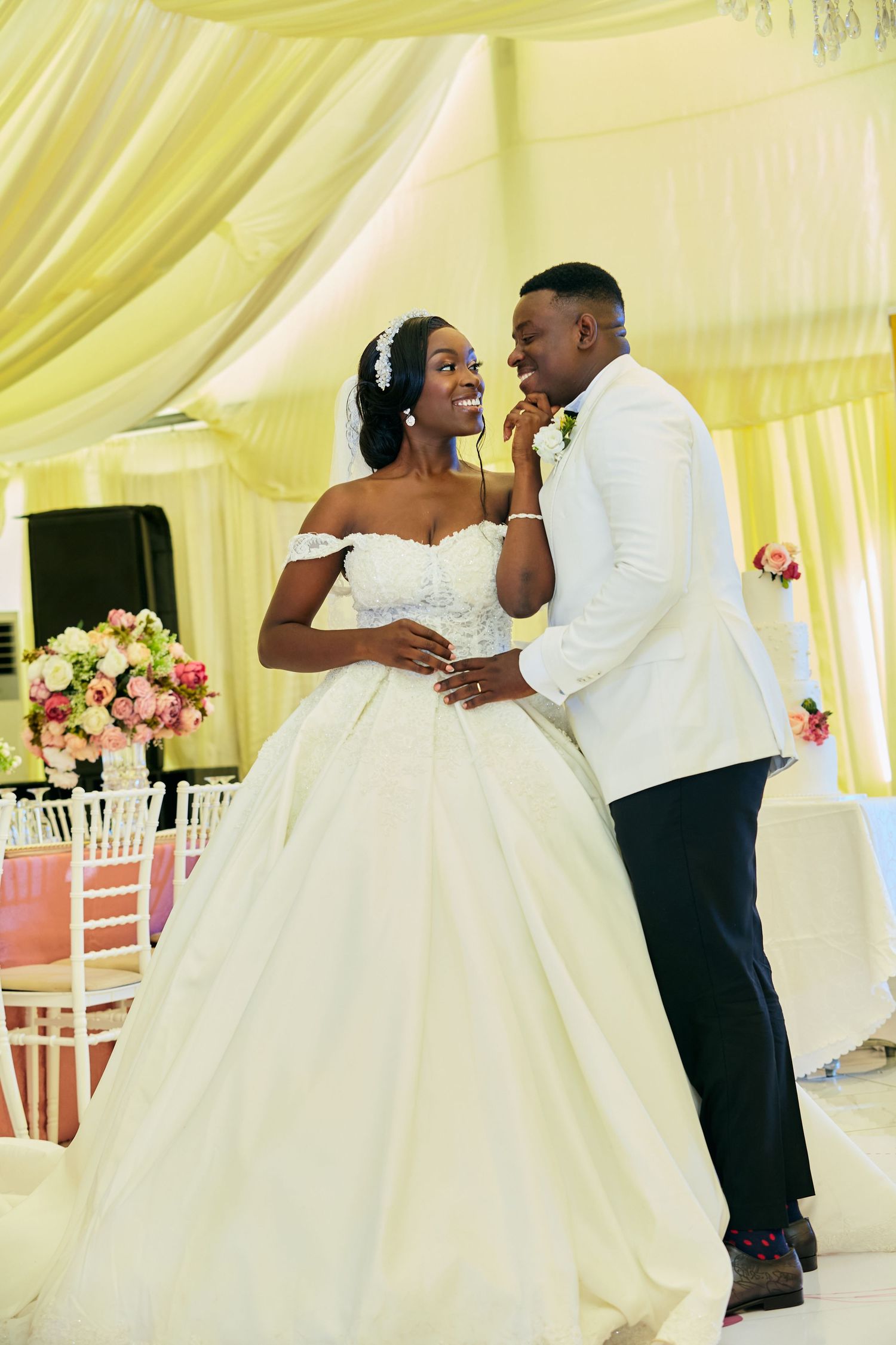 Newlyweds share intimate dance in ballgown and white jacket.
