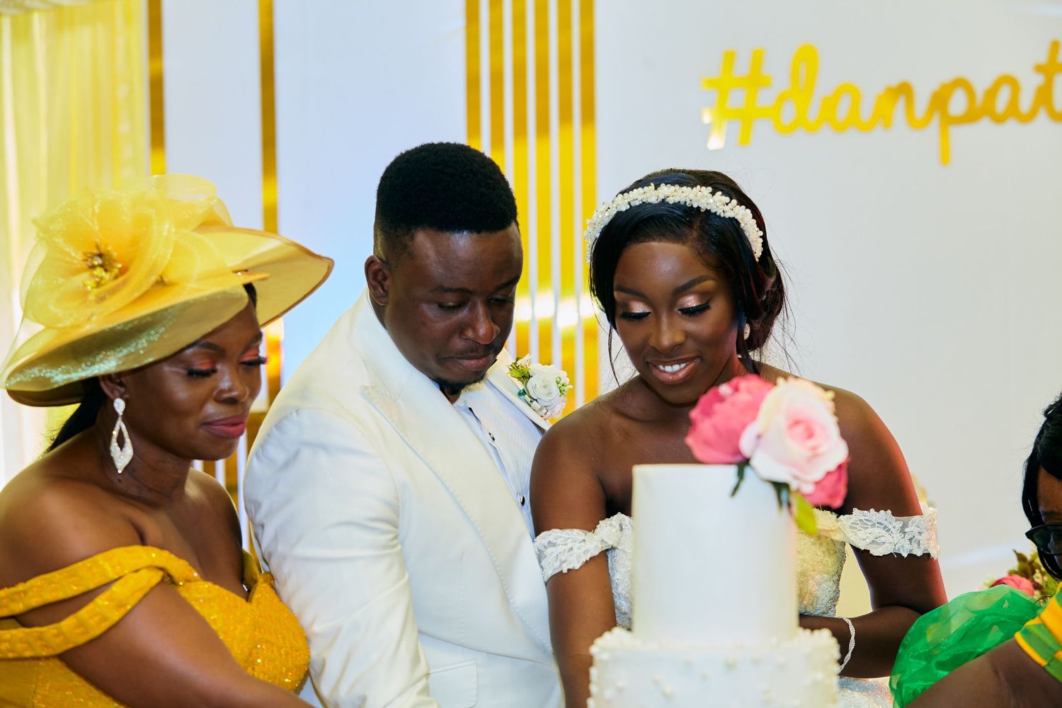 Wedding reception scene with yellow decor and guests in formal attire.