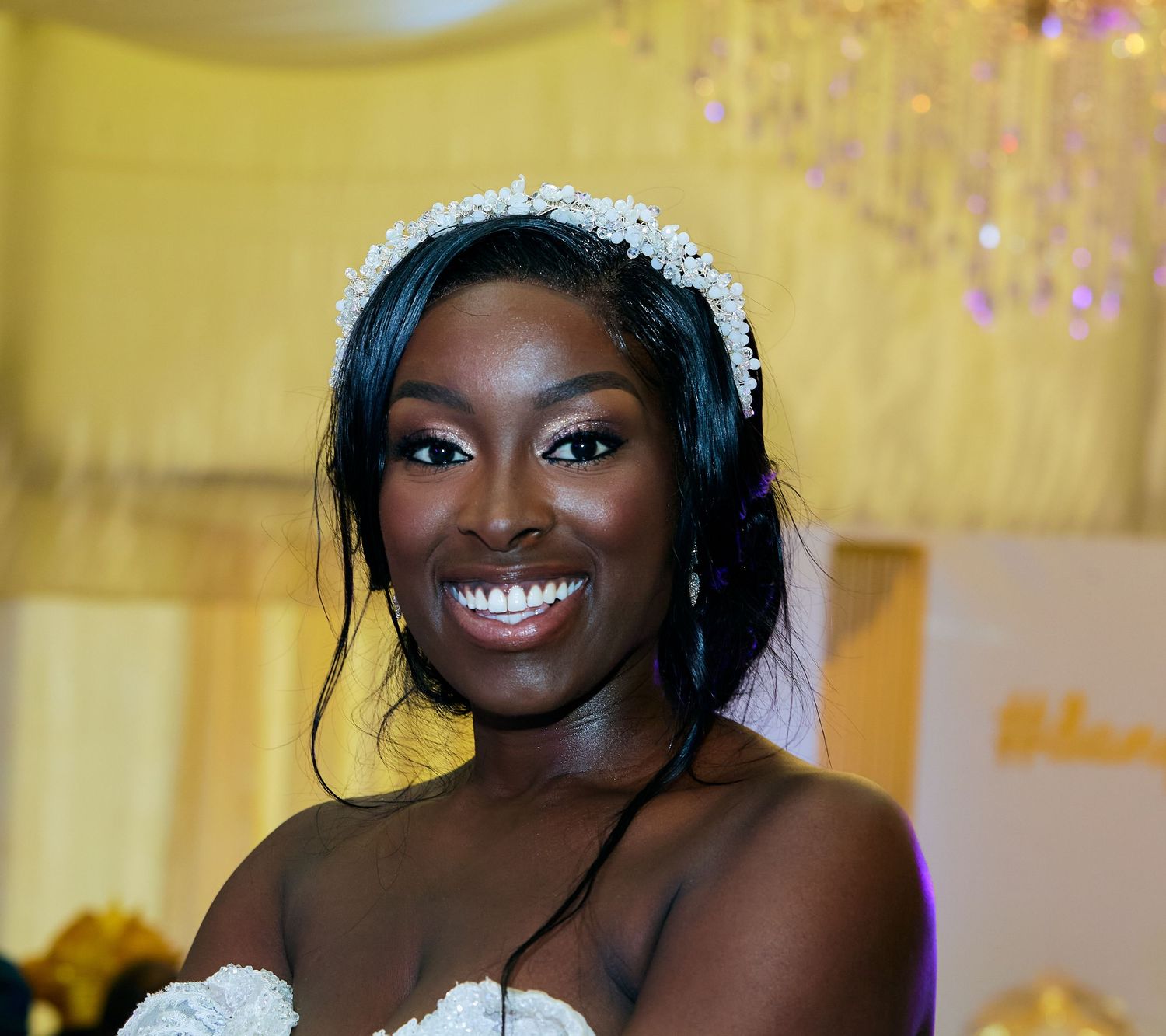 Elegant bridal portraits with crystal crown and lace gown against yellow backdrop.