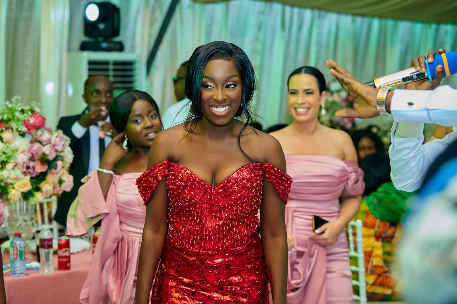 Wedding party members celebrating with pink and red formal attire.