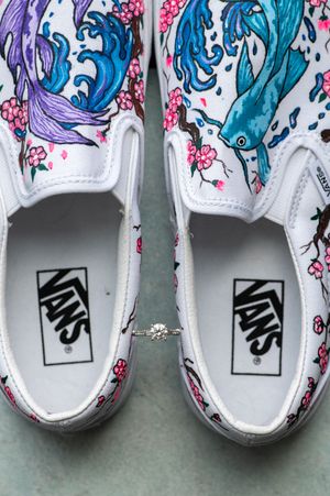 Collection of white Vans sneakers decorated with blue wave patterns and pink cherry blossoms on the upper design. primrose cottage photos