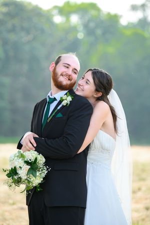 A joyful couple shares intimate moments in a series of romantic outdoor wedding portraits in a sunlit field.