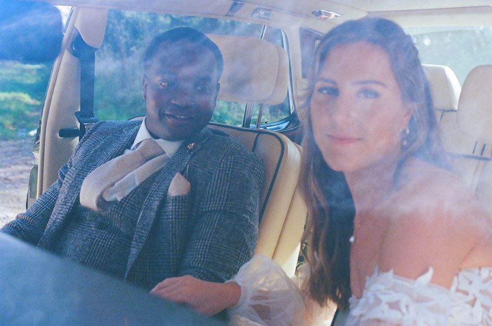 Passengers enjoying a celebratory moment in a car with champagne.