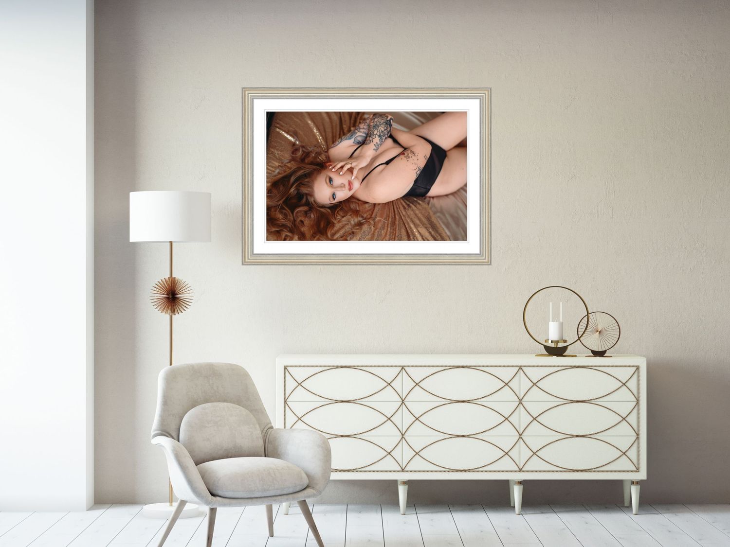 A dark haired woman poses during her boudoir session while looking at the camera laying on a bed in a cape girardeau boudoir studio
