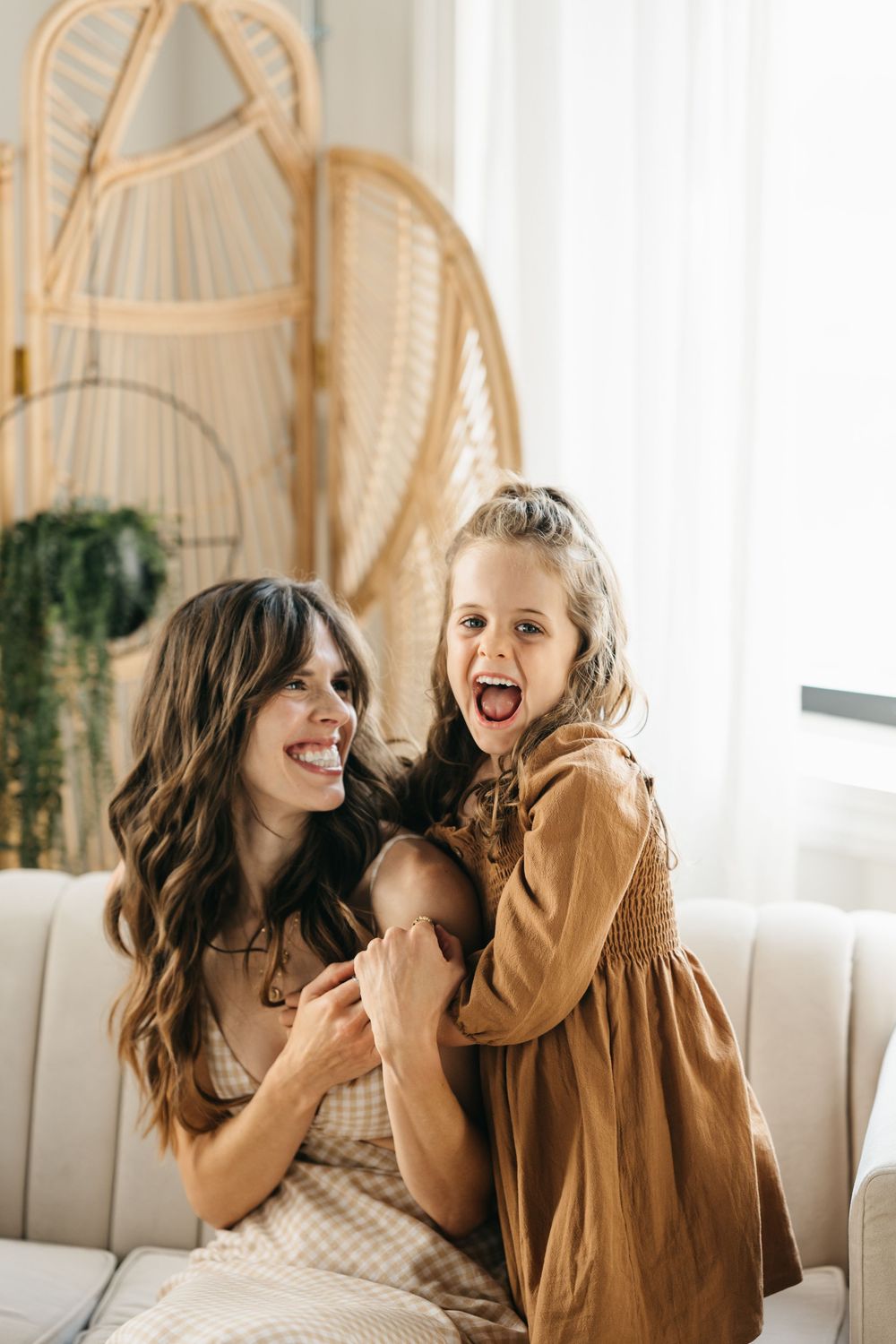A joyful moment captured in a series of candid photos showing playful laughter and natural interaction in a bright room.