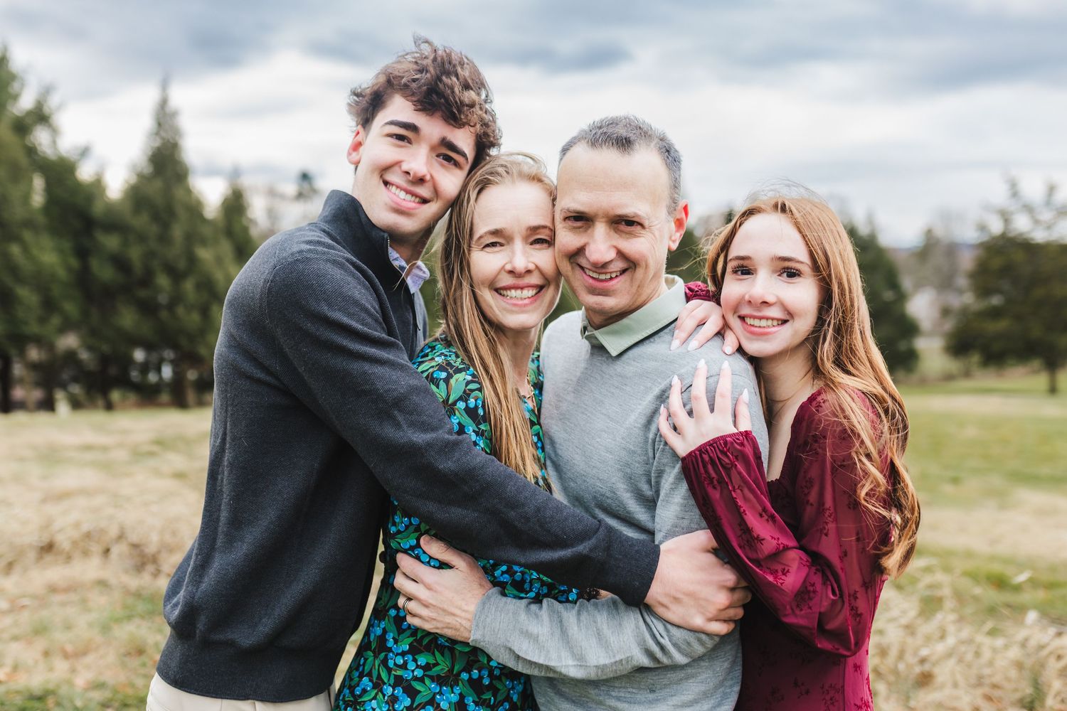 A candid moment of laughter and bonding outdoors during an autumn photoshoot.