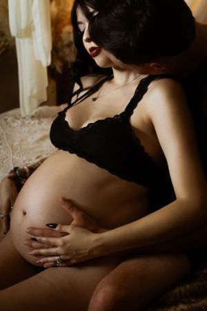 A couple celebrates the growth of their family during this intimate maternity boudoir session in Dallas.