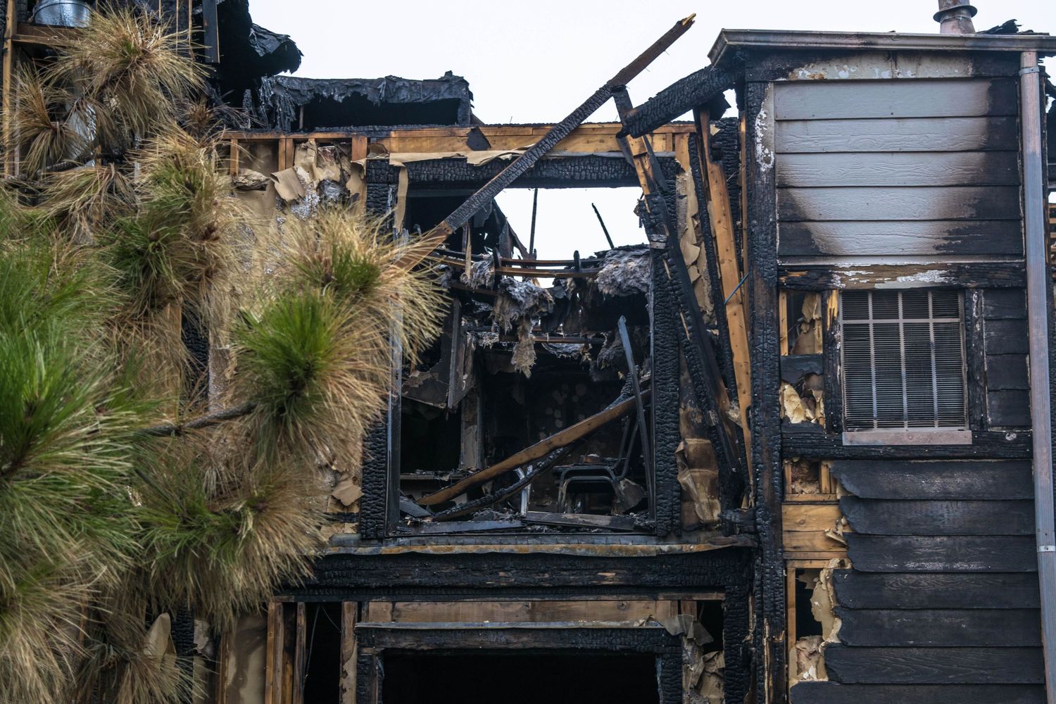 Charred remains of a burned building showing severe fire damage to the structure.