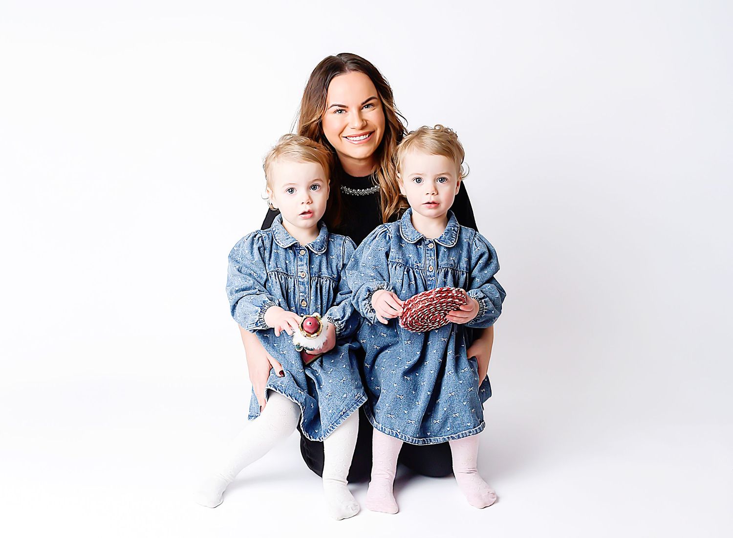 Mother and daughters studio photography by Nicola in Woodside, clean white background portrait capturing love, and connection.