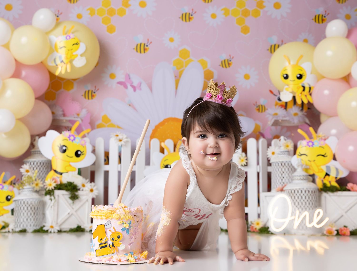 Whimsical bee themed party setup with yellow and pink balloon decorations.