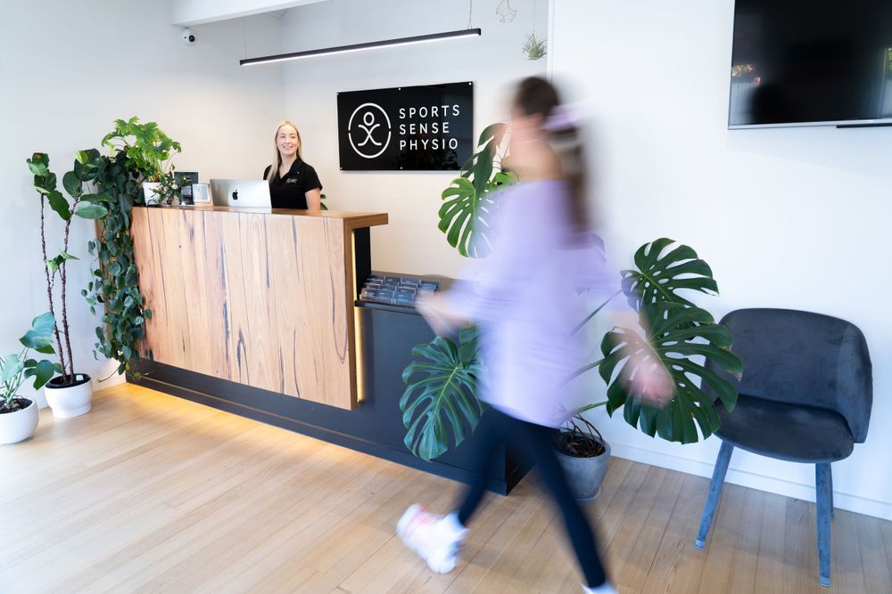 Modern physical therapy clinic reception area with plants and blurred motion.