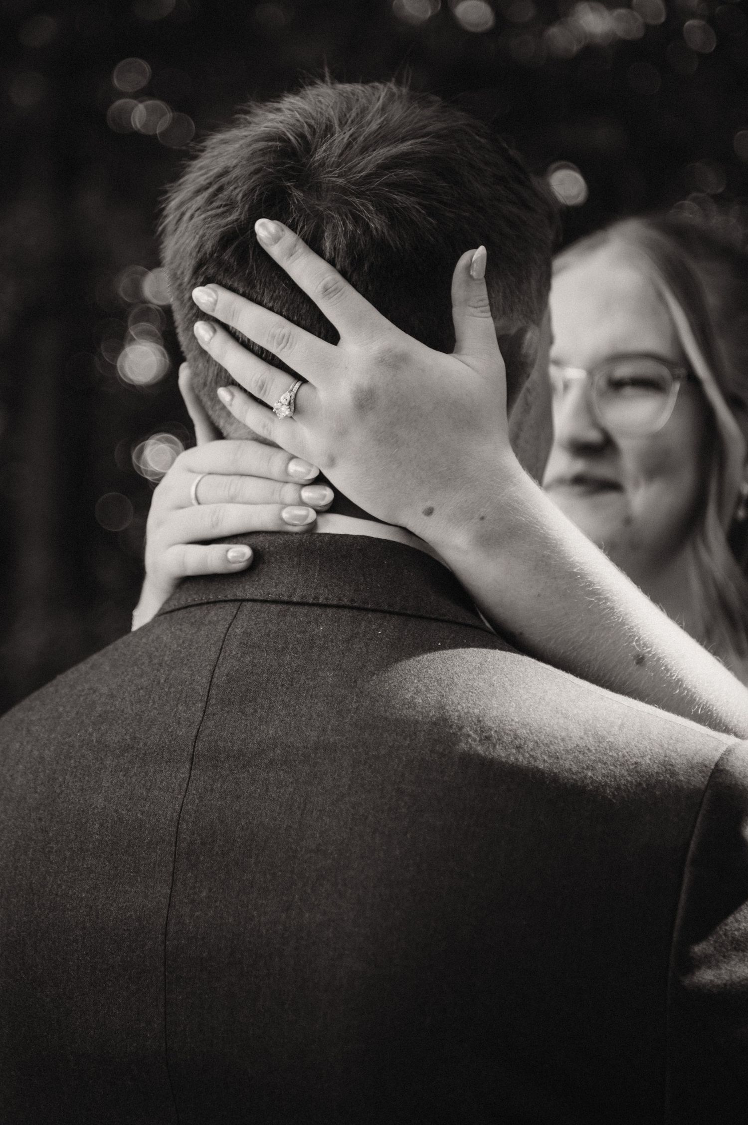 Black and white baptism ceremony moment showing water being poured.