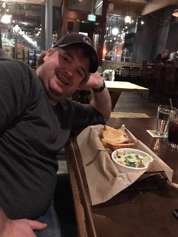 Restaurant patron enjoying a casual meal at a cozy pub-style establishment.