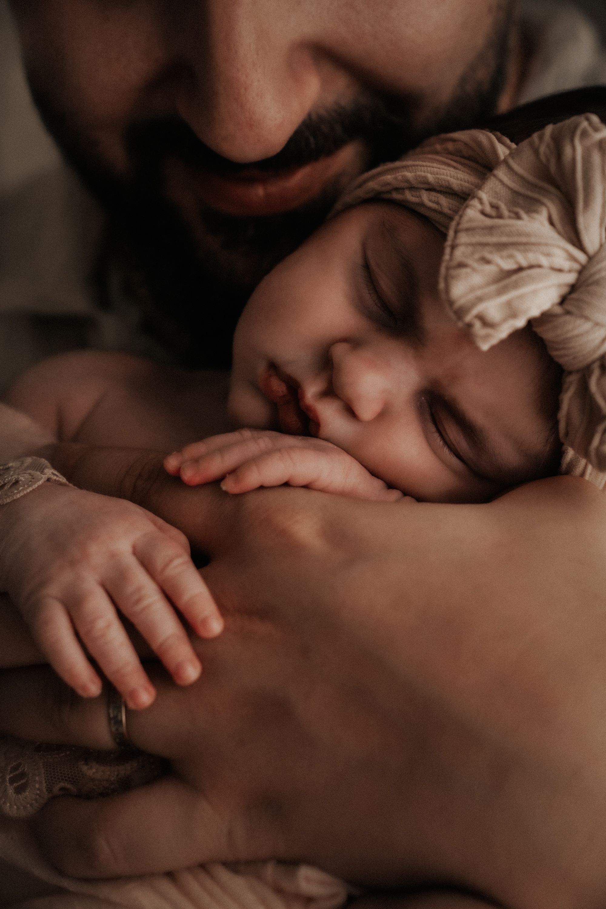 A peaceful sleeping baby nestled in a tender embrace.