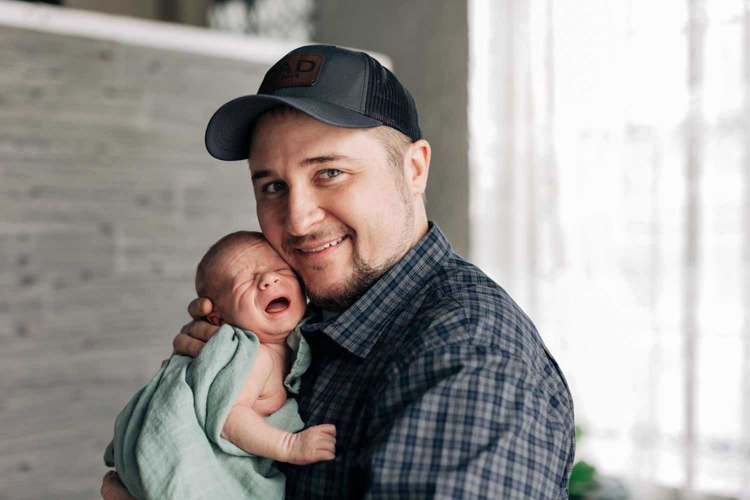 A joyful moment captured indoors with natural window lighting.