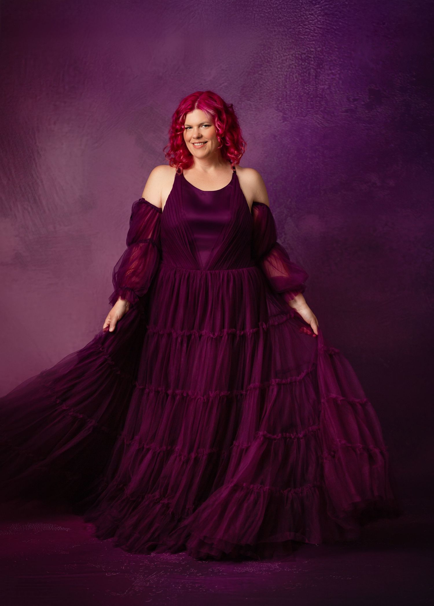 Short lilac party dress with tulle skirt against floral backdrop with large purple satin bows.