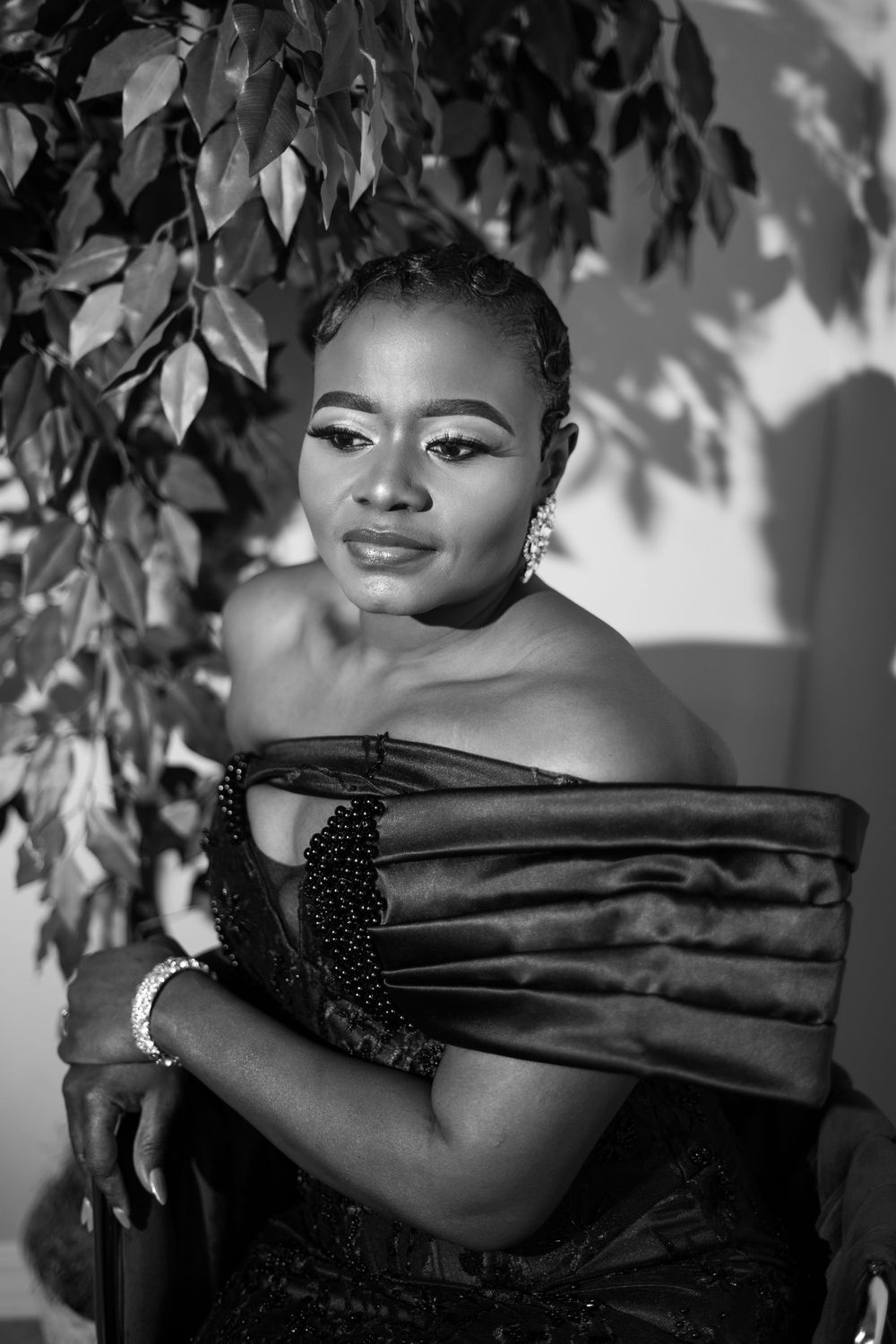 Classic black and white portrait with artistic leaf shadows.