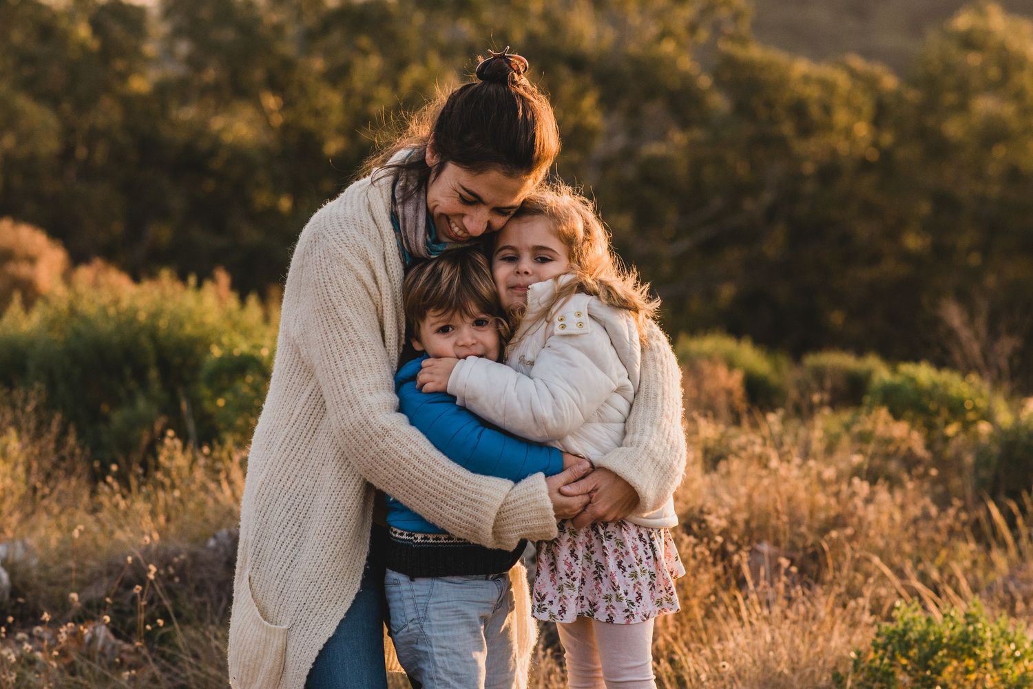 Vale Otero abrazando a sus hijos durante el atardecer en Tandil