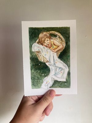 Watercolor painting of a child sleeping in a wicker basket with a white blanket, held by hand against a white wall.