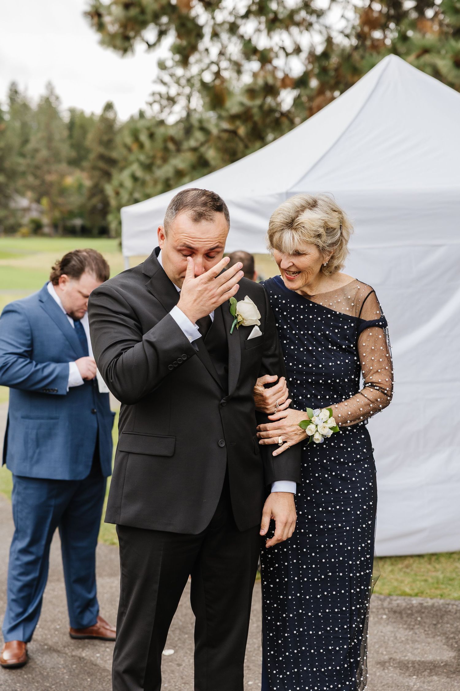 A sequence of candid emotional moments between wedding guests and family members at an outdoor reception.