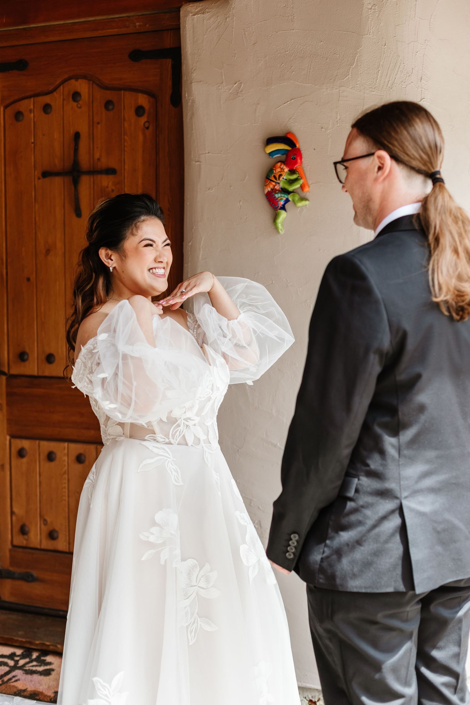 A joyful moment captured during a wedding as people interact in a rustic indoor setting.