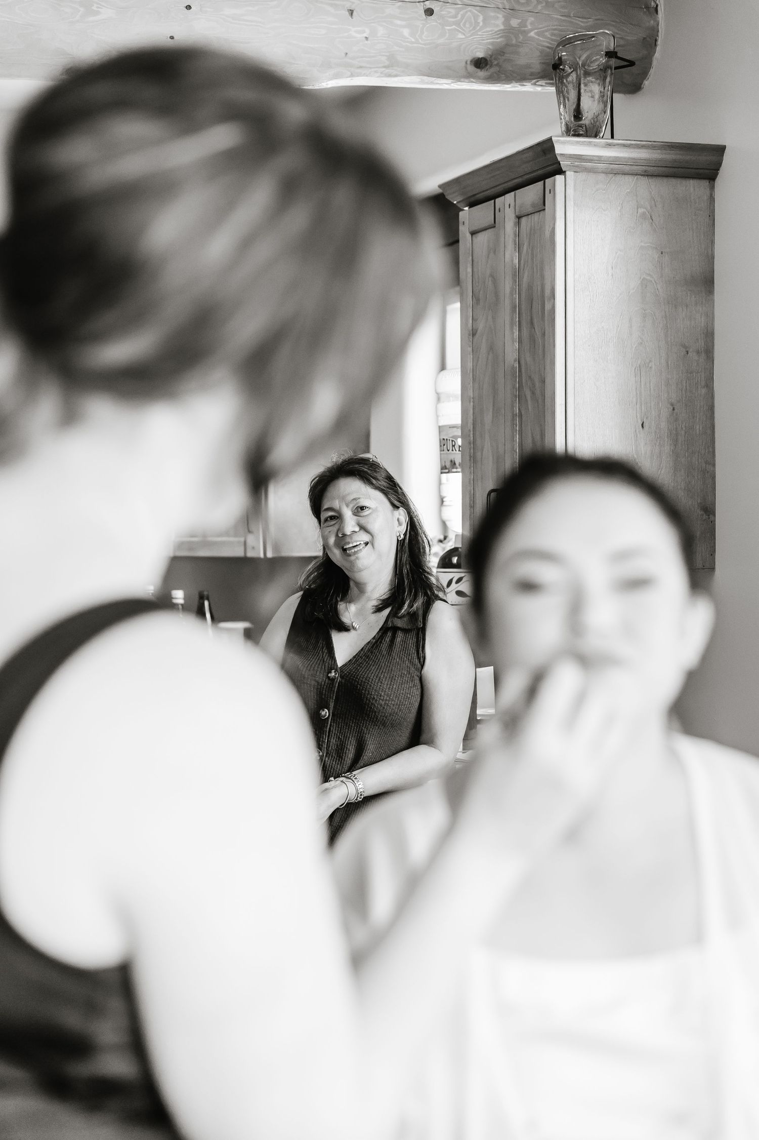 Black and white candid getting ready photos show joyful moments before a wedding ceremony.