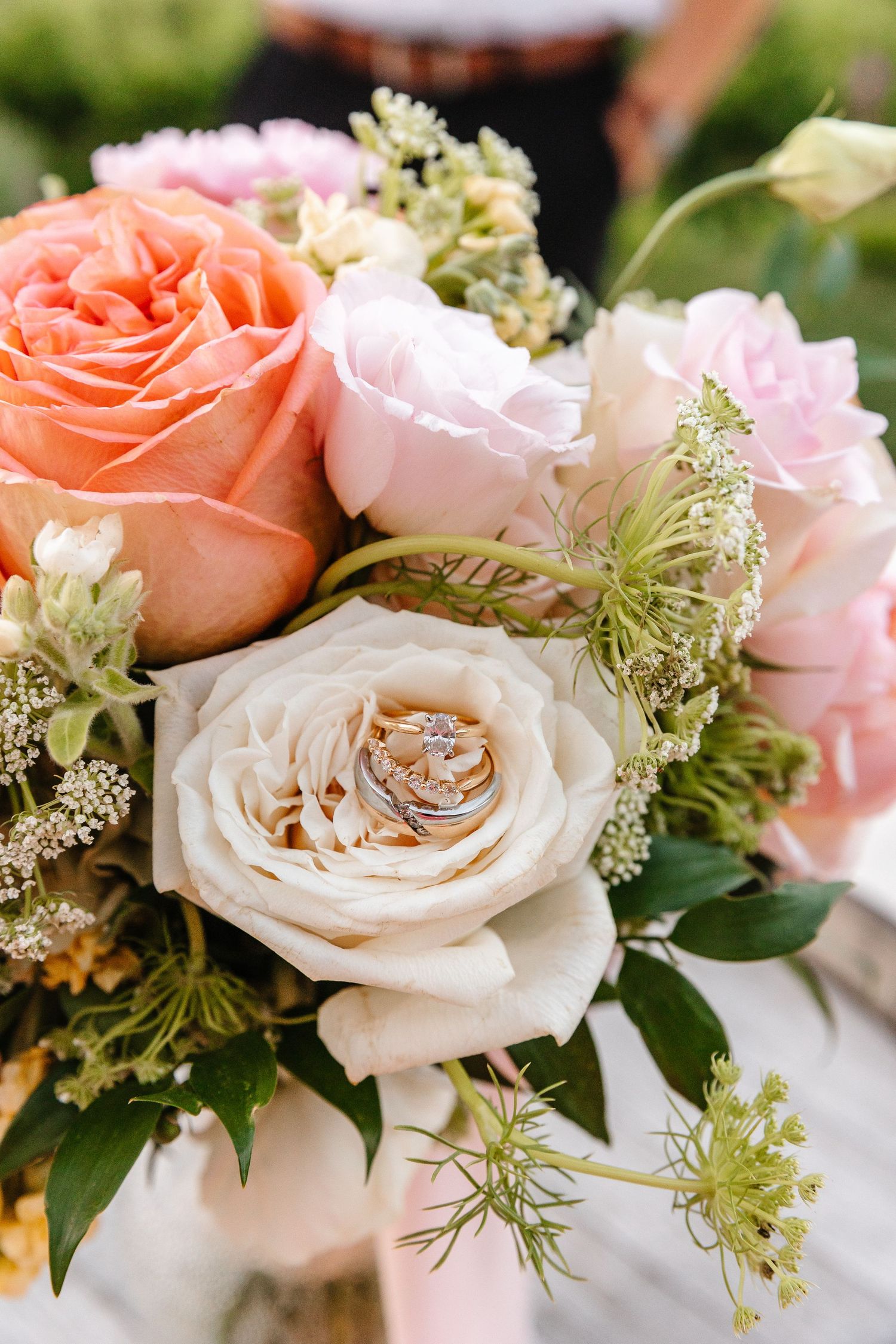 A close-up series of elegant wedding bouquet details featuring blush pink and coral roses with delicate white filler flowers.